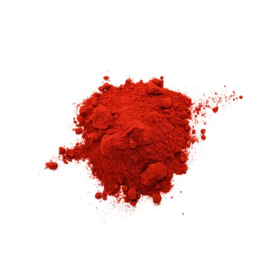 Red powder representing vitamin B12, placed on a white background.